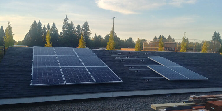 Students installing a 3kW Solar PV system. Left side is a SolarEdge DC optimized system and the right is a Enphase microinverter system.