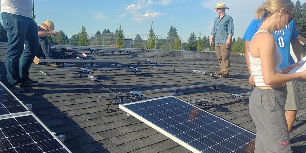 Close up of students installing solar panels at Clackamas Community College