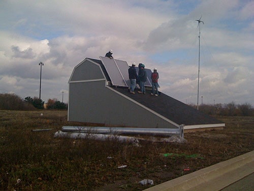 Students at Heartland Community College installing solar panels on a roof