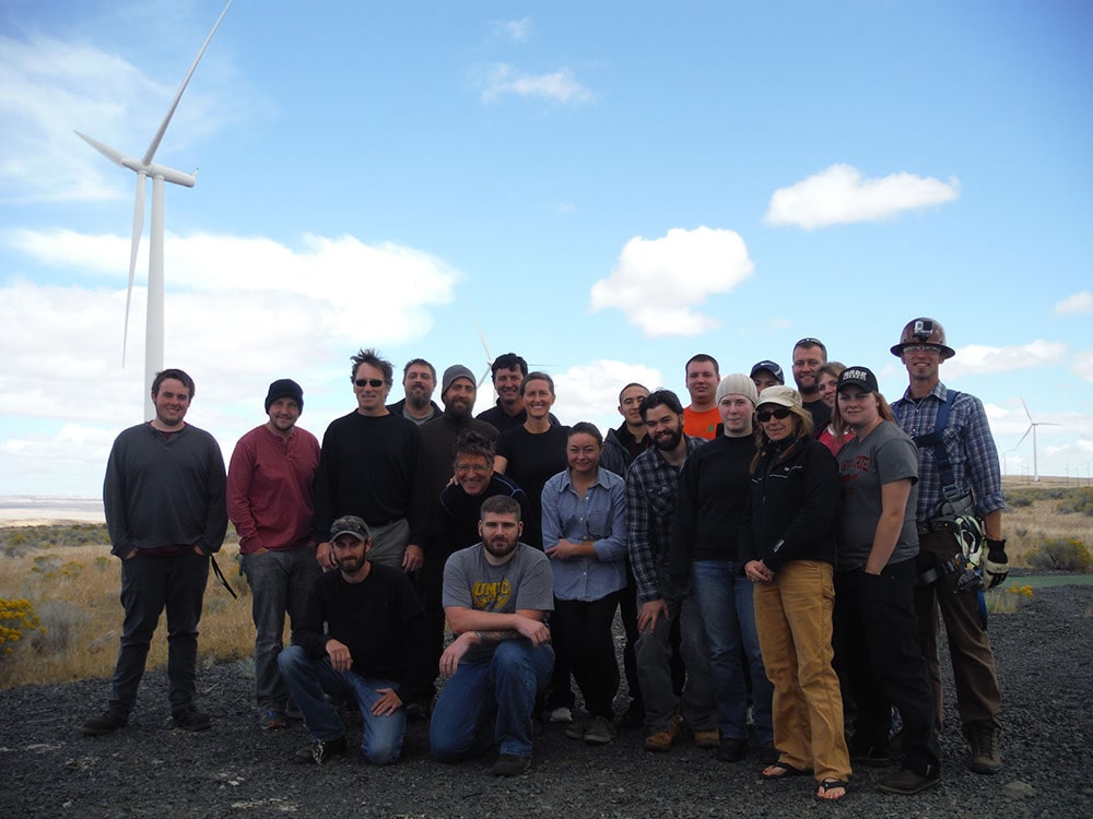 Students from the Columbia Gorge Wind Energy program in front of a wind turbine