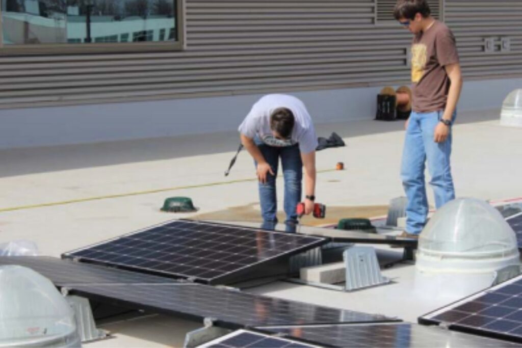 Two students working on solar panels at Northeast Wisconsin Technical College