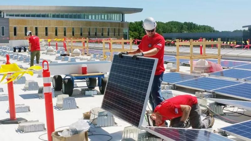 Technicians from Madison College installing solar panels