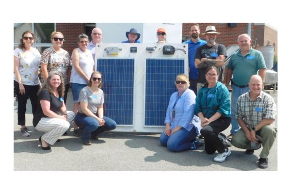 Central Carolina Community College workshop faculty participants in front of solar panels.