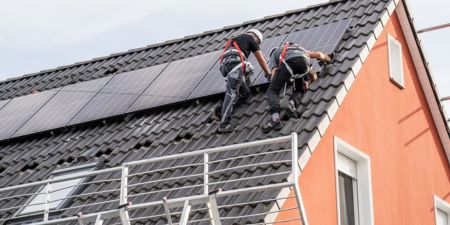 Solar installers on roof.