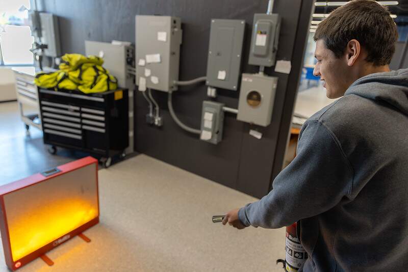 Student attempting to put out a virtual class C fire during Town of Normal’s fire safety activity. Every student in the Batteries Technology must complete this activity.