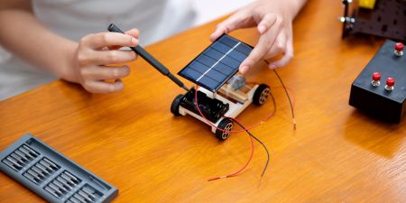 Solar powered car kit with student.