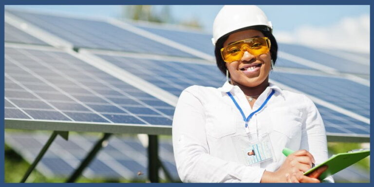 Woman on solar field with hard hat.