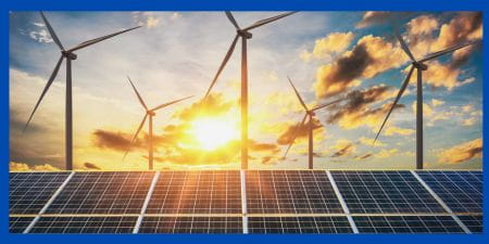 Wind Turbines and solar panels with sunrise.