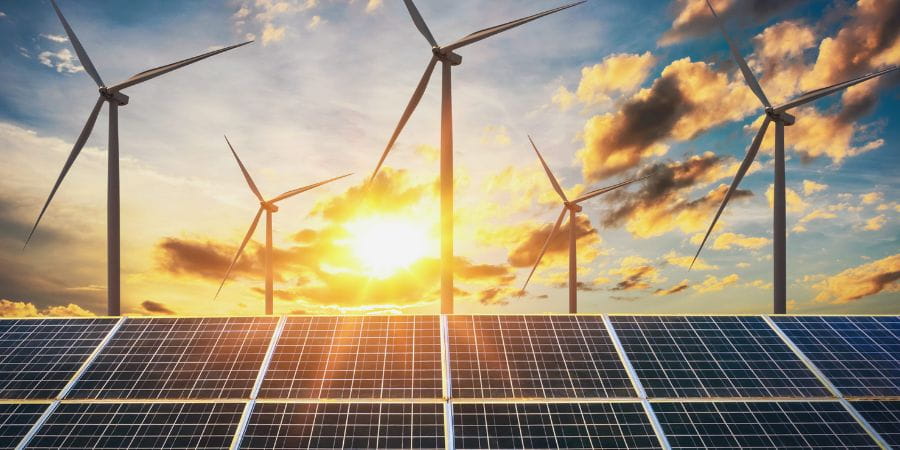 Wind turbines, solar panels and the sunrise.