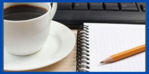 Coffee Cup, key board, note pad and pencil